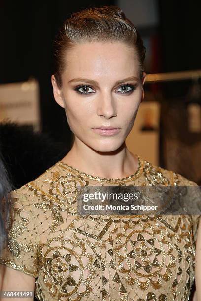 Model prepares backstage at the Reem Acra fashion show during Mercedes-Benz Fashion Week Fall 2014 at The Salon at Lincoln Center on February 10,...