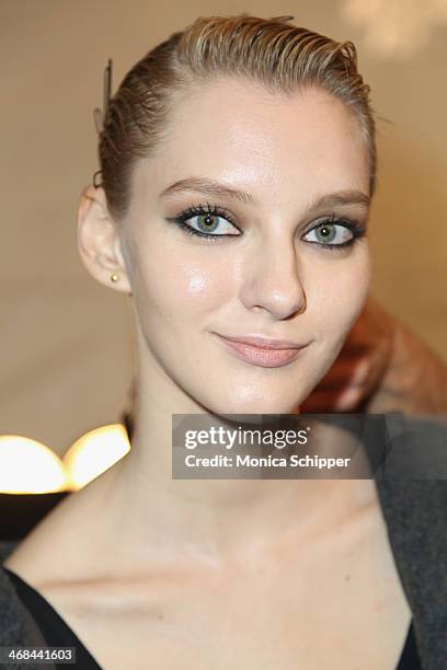 Model prepares backstage at the Reem Acra fashion show during Mercedes-Benz Fashion Week Fall 2014 at The Salon at Lincoln Center on February 10,...