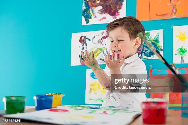 little boy painting - kids arts and crafts stock pictures, royalty-free photos & images