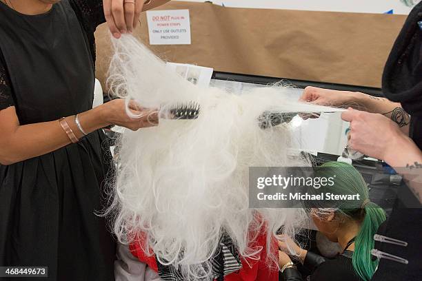 Model prepares before the Thom Browne Women's show during Mercedes-Benz Fashion Week Fall 2014 at Center 548 on February 10, 2014 in New York City.