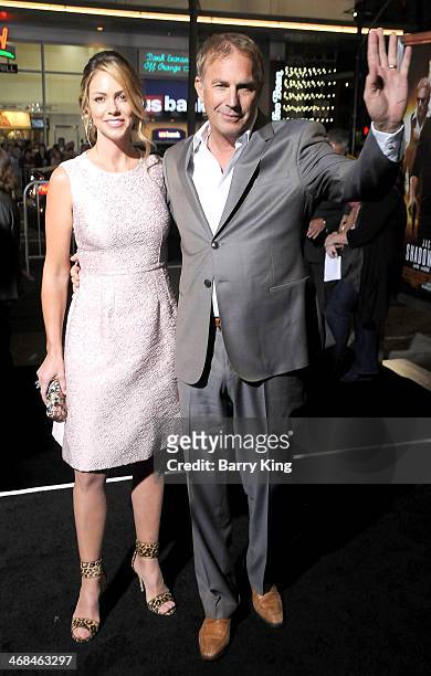 Actor Kevin Costner and wife Christine Baumgartner arrive at the Los Angeles Premiere 'Jack Ryan: Shadow Recruit" on January 15, 2014 at TCL Chinese...