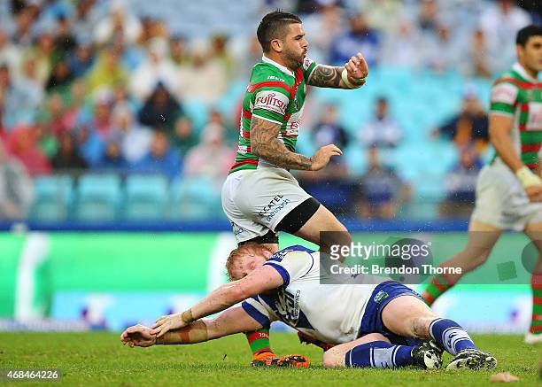 James Graham of the Bulldogs attempts a late tackle on Adam Reynolds of the Rabbitohs while attempting a field goal during the round five NRL match...