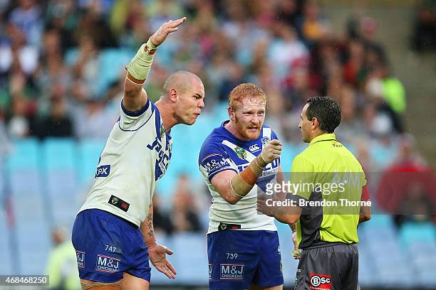 David Klemmer and James Graham of the Bulldogs confront referee, Gerard Sutton after awarding the Rabbitohs a late penalty during the round five NRL...