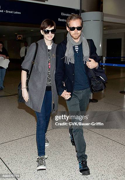 Anne Hathaway and Adam Shulman are seen at LAX on December 12, 2012 in Los Angeles, California.