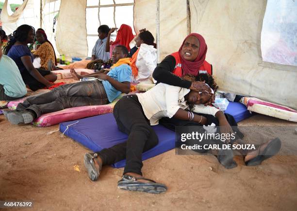 Students evacuated from Moi University during a terrorist seige is treated for shock by a member of the Red-Cross in Garissa on April 3, 2015....