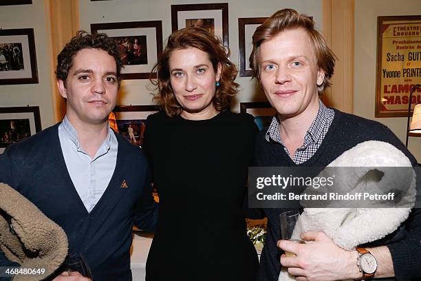 Actress Emmanuelle Devos standing between actors from 'La revue de presse de Catherien et Liliane', Alex Lutz and Bruno Sanches attend 'La Porte a...