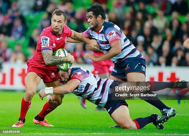 Quade Cooper of the Reds is tackled during the round eight Super Rugby match between the Rebels and the Reds at AAMI Park on April 3, 2015 in...