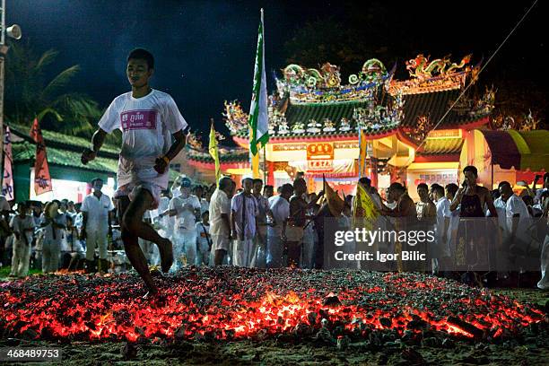 Devotee of Chinese Jeng Ong shrine walking on burning charcoal as the Vegetarian Festival in Phuket is in full swing. The Phuket Vegetarian Festival...