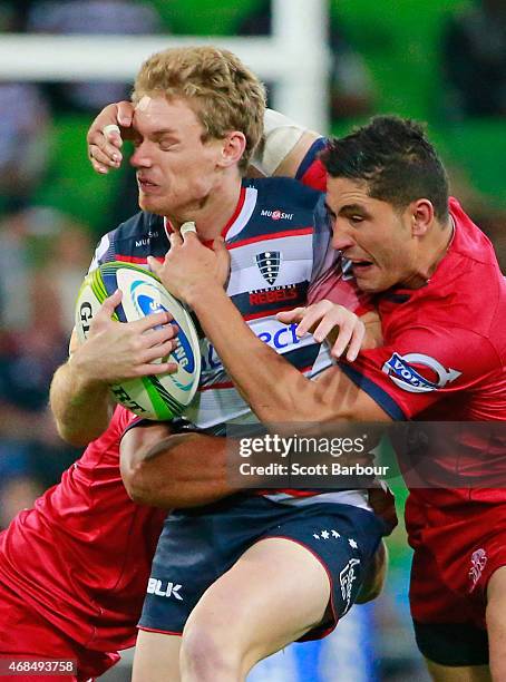 Bryce Hegarty of the Rebels is tackled during the round eight Super Rugby match between the Rebels and the Reds at AAMI Park on April 3, 2015 in...