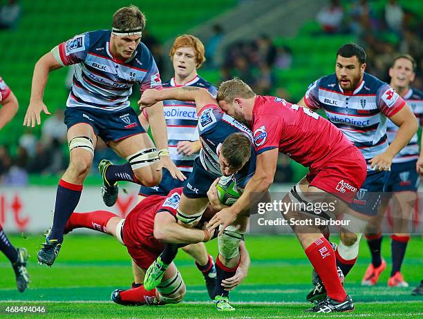 Sean McMahon of the Rebels is tackled during the round eight Super Rugby match between the Rebels and the Reds at AAMI Park on April 3, 2015 in...