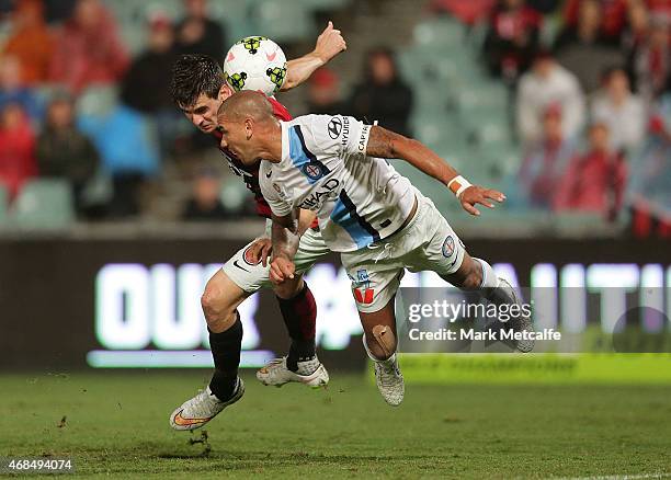 Tomi Juric of the Wanderers and Patrick Kisnorbo of Melbourne compete in the air during the round 24 A-League match between the Western Sydney...