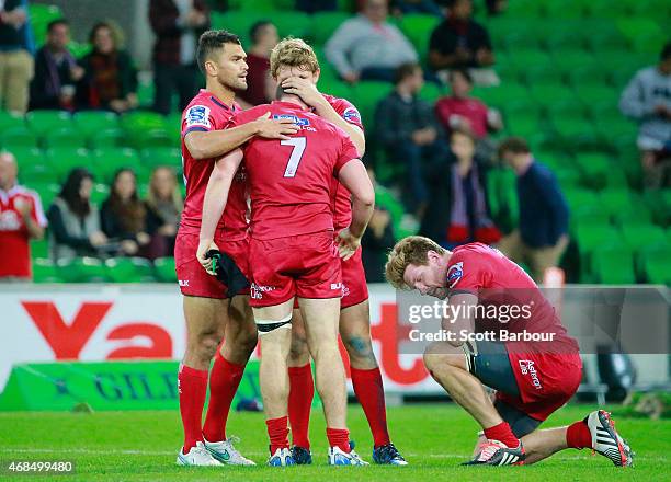 Karmichael Hunt consoles Liam Gill of the Reds as the final siren sounds as the Reds lose during the round eight Super Rugby match between the Rebels...