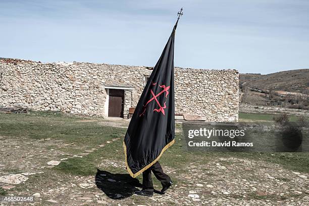 Worshippers of the brotherhood of 'La Cofadria de la Vera Cruz y El Cristo de las Lluvias' walk the way of the cross or 'Via Crucis' in Alustante on...