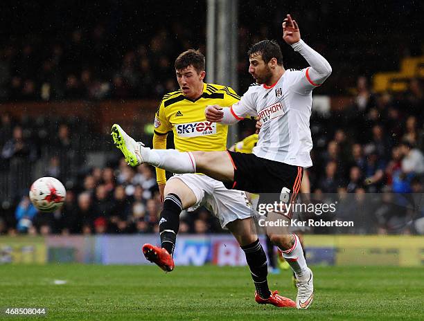 Chris Long of Brentford and Nikolay Bodurov of Fulham challenge for the ball during the Sky Bet Championship match between Fulham and Brentford at...