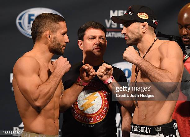 Opponents Chad Mendes and Ricardo Lamas face off during the UFC weigh-in at the Patriot Center on April 3, 2015 in Fairfax, Virginia.