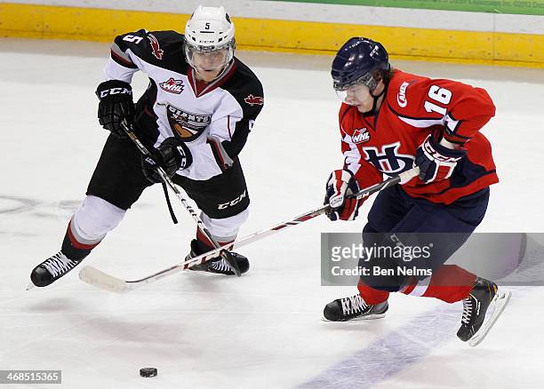 Tyler Morrison of the Vancouver Giants fights for the puck against Reid Duke of the Lethbridge Hurricanes during their WHL game at the Pacific...
