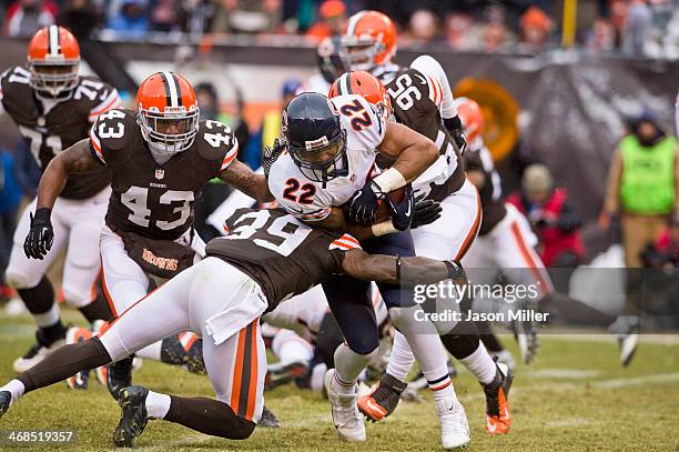 Running back Matt Forte of the Chicago Bears runs for a gain while under pressure from free safety Tashaun Gipson, strong safety T.J. Ward and...