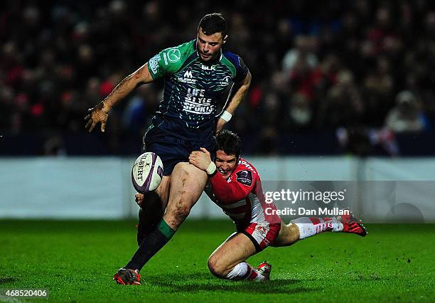 Robbie Henshaw of Connacht is tackled by James Hook of Gloucester during the European Rugby Challenge Cup match between Gloucester and Connacht at...