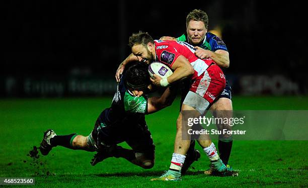 Gloucester centre Bill Meakes is tackled by Eoghan Masterson and Tom McCartney during the European Rugby Challenge Cup Quarter Final match between...