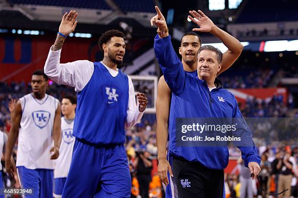 Head coach John Calipari of the Kentucky Wildcats acknowledges the fans with Willie Cauley-Stein and Dakari Johnson during practice for the NCAA...