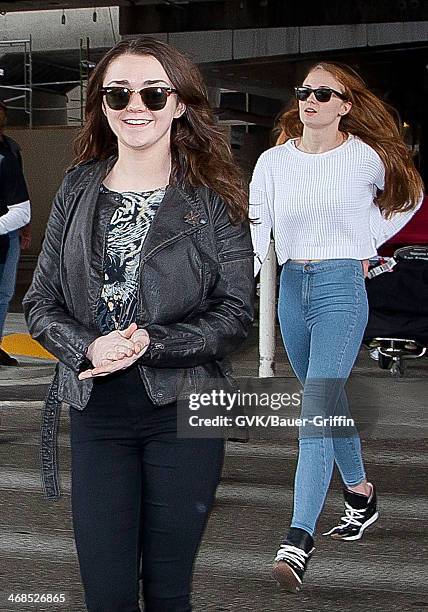 Maisie Williams and Sophie Turner are seen at Los Angeles International Airport on March 16, 2013 in Los Angeles, California.