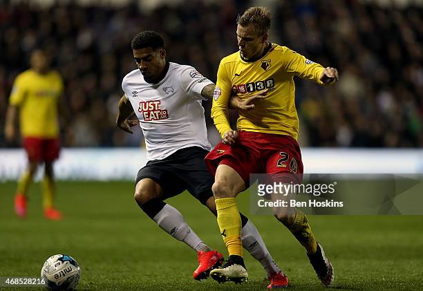 Cyrus Christie of Derby holds off the challenge of Matej Vydra of Watford during the Sky Bet Championship match between Derby County and Watford at...