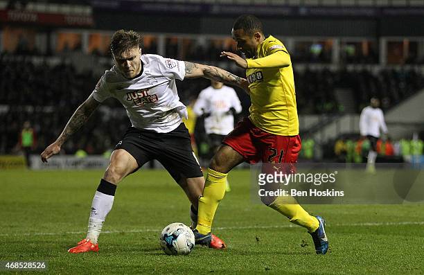 Ikechi Anya of Watford holds off pressure from Jeff Hendrick of Derby during the Sky Bet Championship match between Derby County and Watford at iPro...