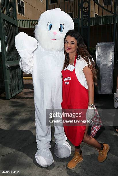 Personality Golnesa "GG" Gharachedaghi poses with an Easter Bunny at the Los Angeles Mission Easter event at the Los Angeles Mission on April 3, 2015...