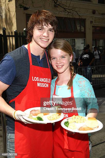 Actors Joel Courtney and Delaney Raye attends the Los Angeles Mission Easter Event held at the Los Angeles Mission on April 3, 2015 in Los Angeles,...