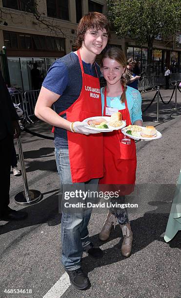 Actors Joel Courtney and Delaney Raye attend the Los Angeles Mission Easter event at the Los Angeles Mission on April 3, 2015 in Los Angeles,...
