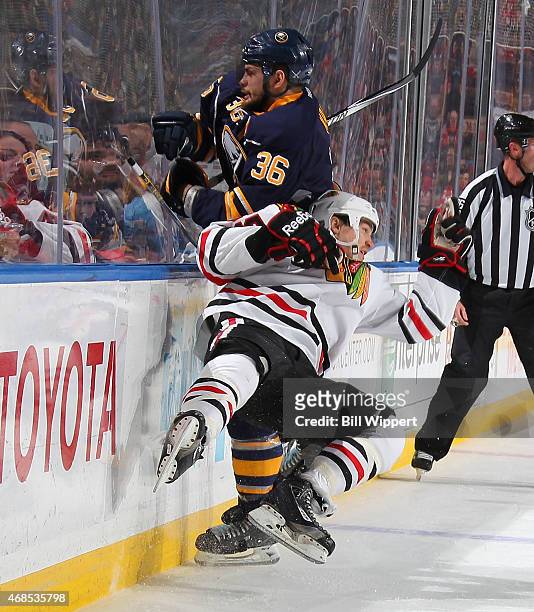 Patrick Kaleta of the Buffalo Sabres checks Andrew Shaw of the Chicago Blackhawks on April 3, 2015 at the First Niagara Center in Buffalo, New York.