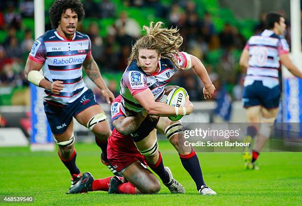 Jordy Reid of the Rebels runs with the ball during the round eight Super Rugby match between the Rebels and the Reds at AAMI Park on April 3, 2015 in...