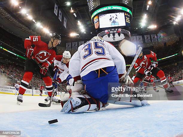 Stefan Matteau of the New Jersey Devils (l0 scores a first period goal against Dustin Tokarski of the Montreal Canadiens at the Prudential Center on...