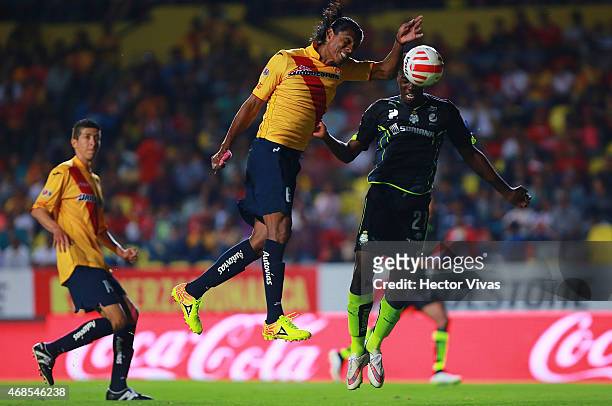Joel Huiqui of Morelia fails to reject the ball as Jorge Djaniny Tavares of Santos Laguna heads to score the first goal of his team during a match...
