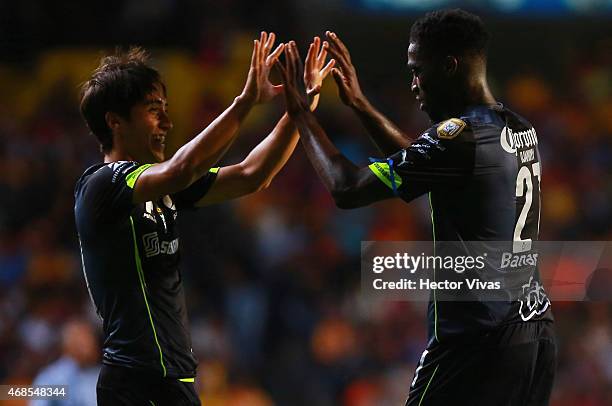 Jorge Djaniny Tavares of Santos Laguna celebrates with Jose Abella after scoring the first goal of his team during a match between Morelia and Santos...