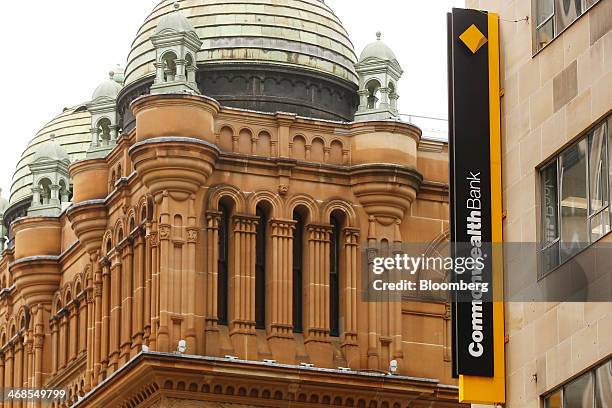 The Commonwealth Bank of Australia logo is displayed outside one of the bank's branches next to the Queen Victoria Building, left, in Sydney,...