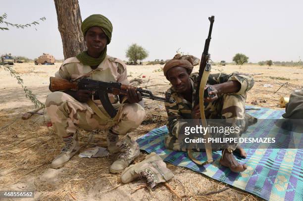 Chadian soldiers pose with their arms near Malam Fatori on April 3 after the town in north-eastern Nigeria was retaken from Boko Haram by troops from...