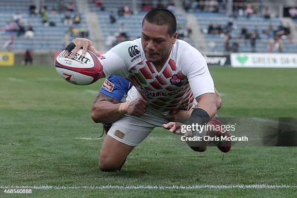 Lomano Lava Lemeki of Japan dives over for a try against Samoa during the match between Japan and Samoa on day one of the Tokyo Sevens Rugby 2015 at...