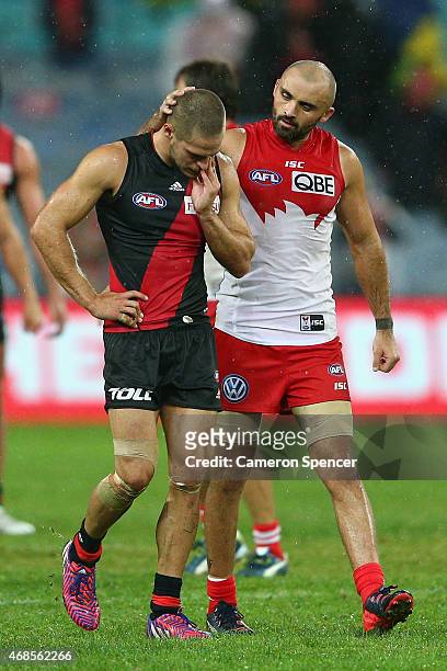 Rhyce Shaw of the Swans embraces David Zaharakis of the Bombers following Swans win in the Round One AFL match between the Sydney Swans and the...