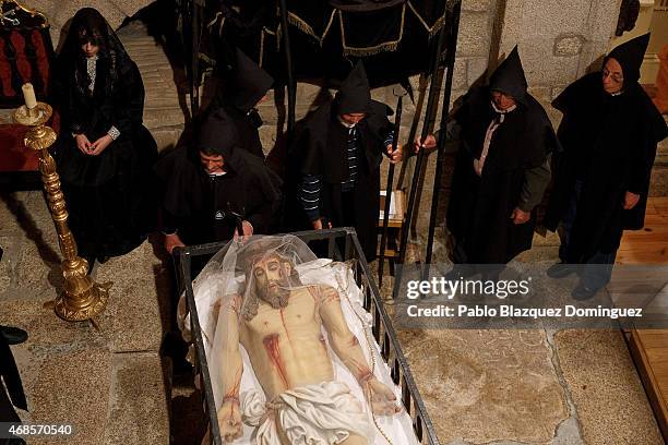 Members of the 'Santa Casa Misericordia' stant next to an image of Jesus Christ during a ceremony on April 3, 2015 in Monsanto, in Idanha A Nova...