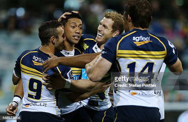 Brumbies players celebrate a try by Christian Lealiifano during the round eight Super Rugby match between the Brumbies and the Cheetahs at GIO...