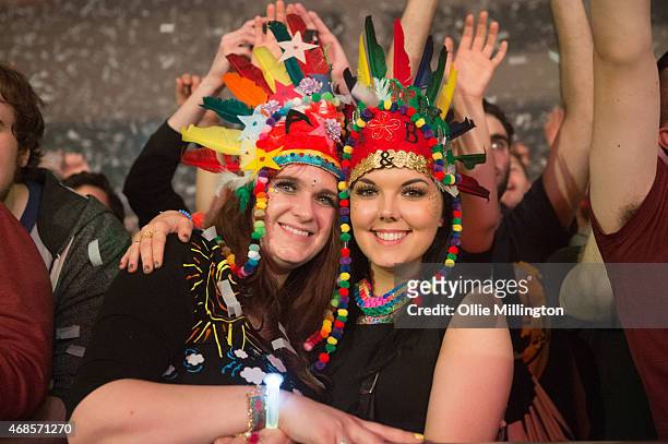 Two member of the crowd with headdresses on pose as Above and Beyond perform on stage during the first of two sold out nights at Brixton Academy on...