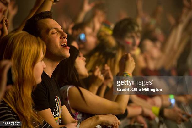 The front row watch on as Above and Beyond perform on stage during the first of two sold out nights at Brixton Academy on April 3, 2015 in London,...