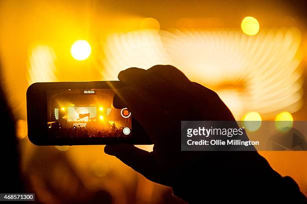 Fan records Above and Beyond performing on stage with a mobile phone during the first of two sold out nights at Brixton Academy on April 3, 2015 in...