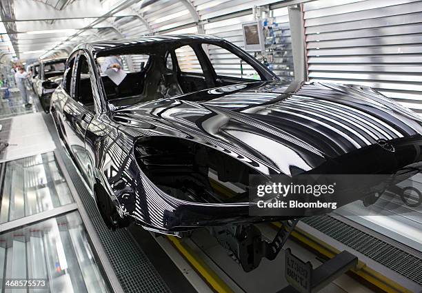 Painted chassis of Porsche Macan sport-utility vehicles pass through the paint shop inside the newly expanded Porsche AG factory in Leipzig, Germany,...