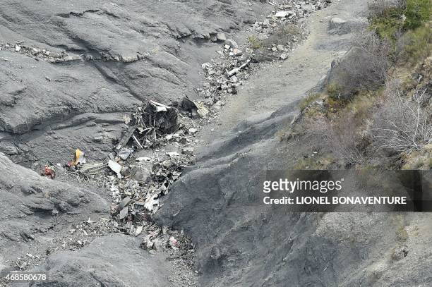 This aerial photo taken from a helicopter on April 3, 2015 shows a close-up view of scattered debris at the crash site of the Germanwings Airbus...