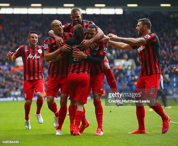 Eduardo Vargas of QPR is congratulated by team mates on scoring the opening goal during the Barclays Premier league match West Bromwich Albion and...