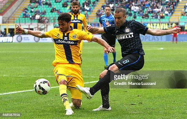 Rodrigo Palacio of FC Internazionale Milano is challenged by Pedro Mendes of Parma FC during the Serie A match between FC Internazionale Milano and...