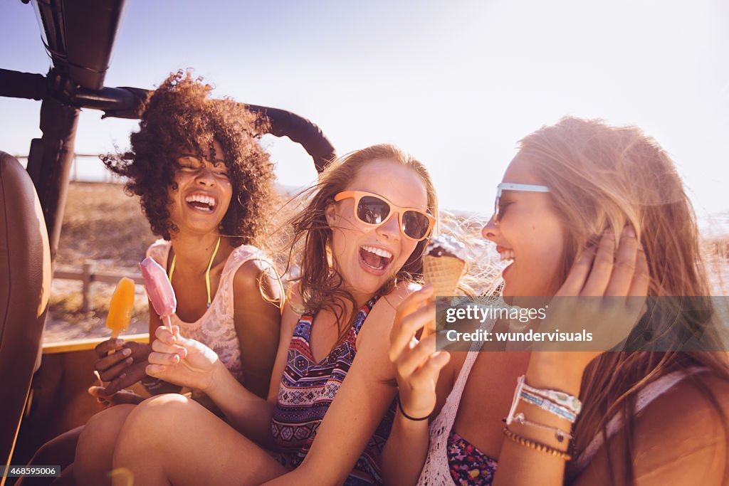 Mixed racial group of teens laughing with ice creams