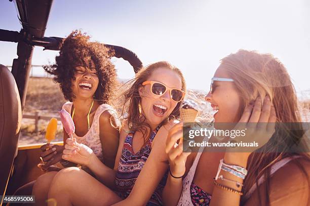 mixed racial group of teens laughing with ice creams - icecream beach stock pictures, royalty-free photos & images